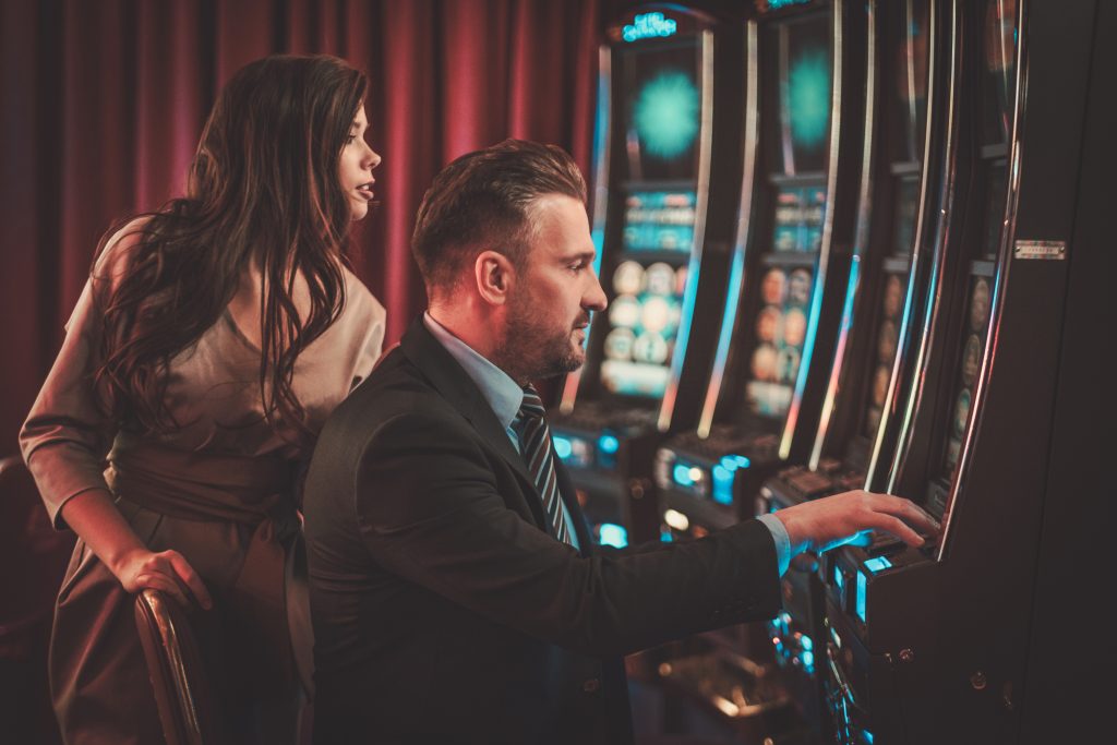 People playing at slot machines in a casino
