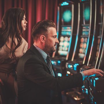 Couple at a Slot Machine in a Casino