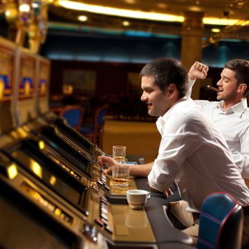 A Couple of Gamblers Enjoying Playing Slots In a Casino