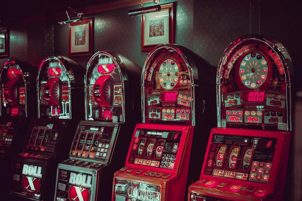  Slot machines in a casino with artwork on the walls
