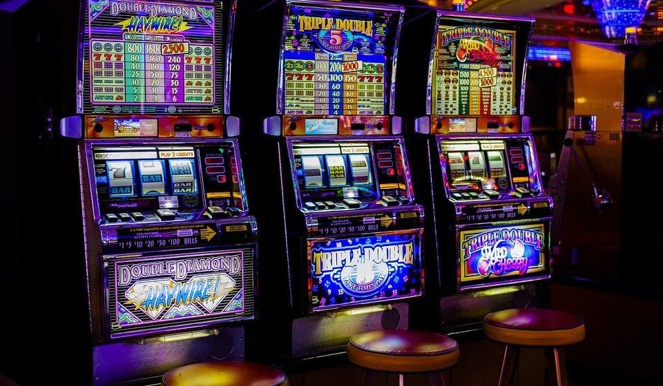 Slot machines in a casino against a dark background