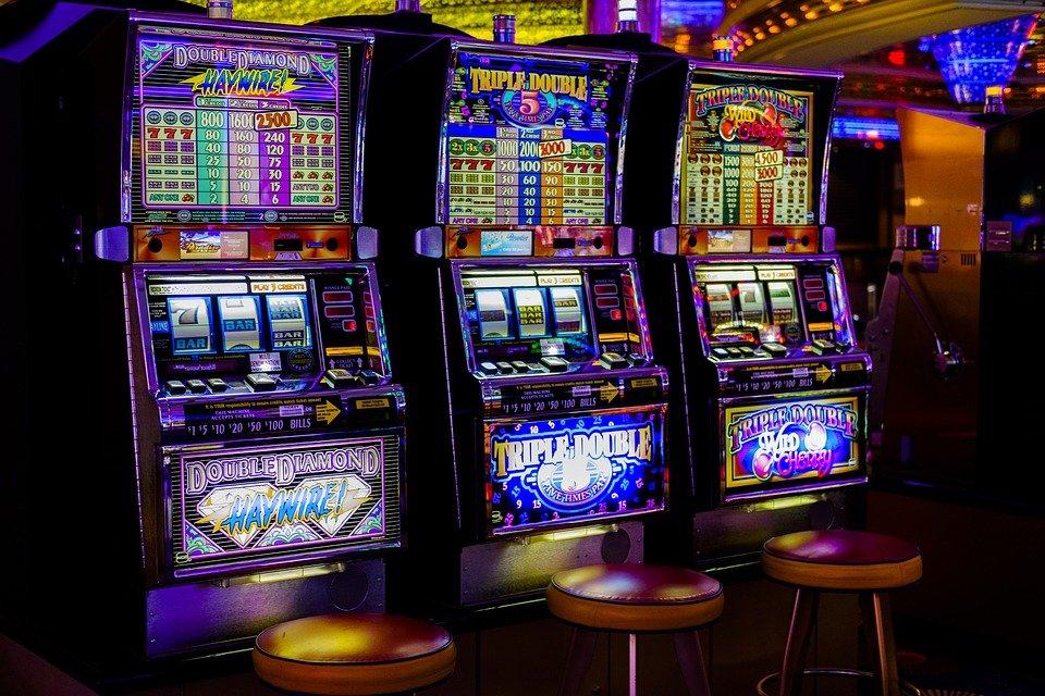 Slot machines in a casino against a dark background