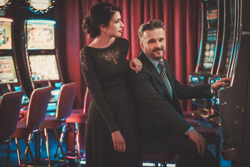 Couple Playing Slots in a Casino