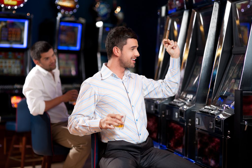 Man Playing Slots at a Casino
