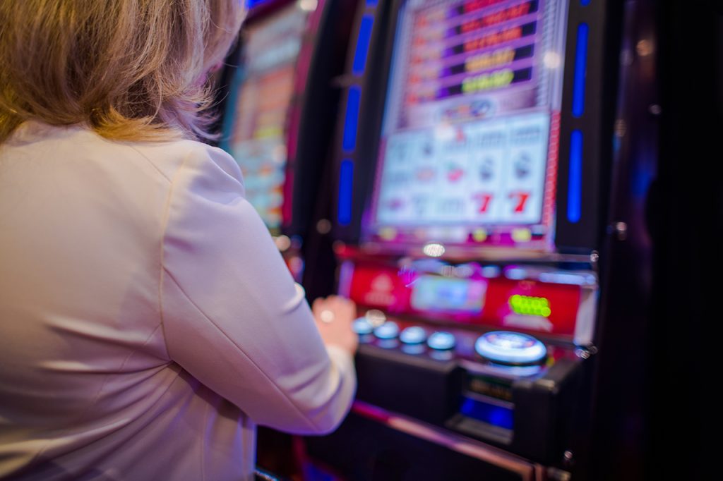 Side View of a Player at a Casino Slot Machine