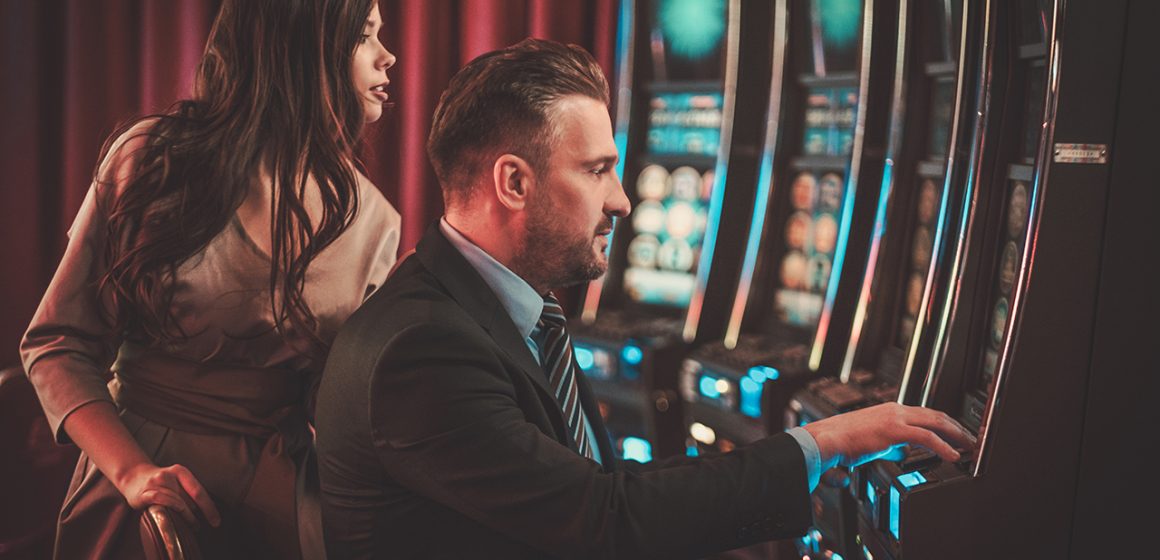 Couple at a Slot Machine in a Casino