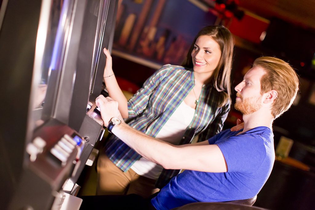 Young Couple Enjoying Slots in a Casino