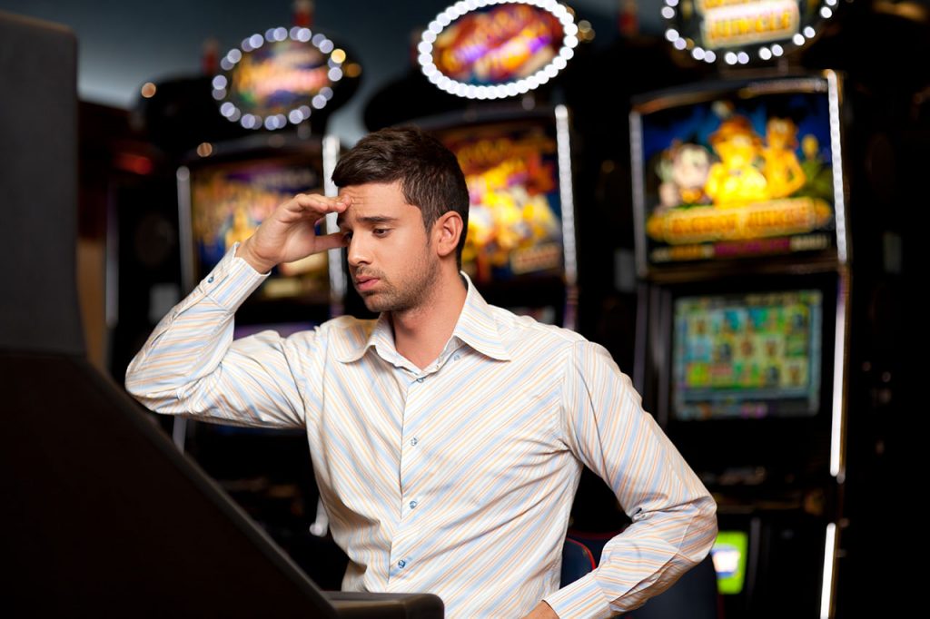 Casino Slot Player Losing at a Slot Machine
