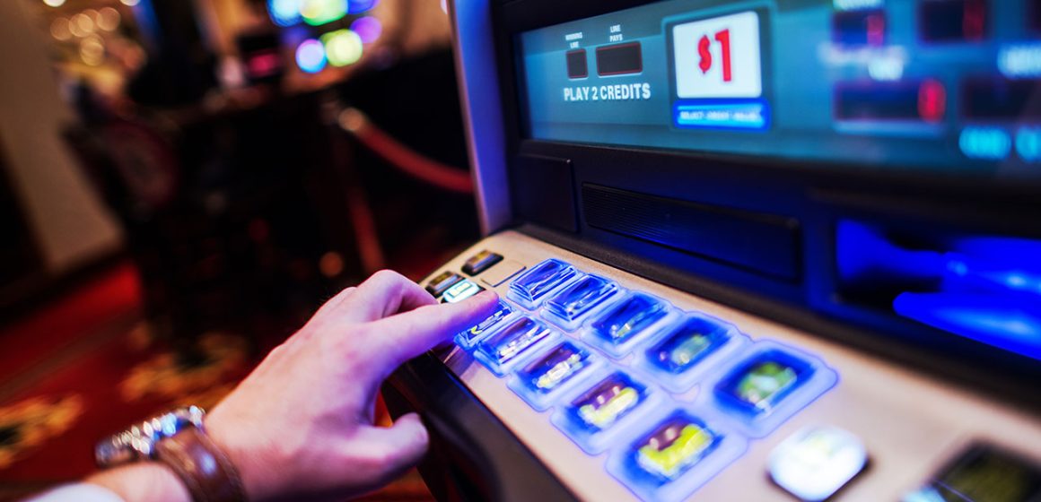 Man Playing a Slot Machine