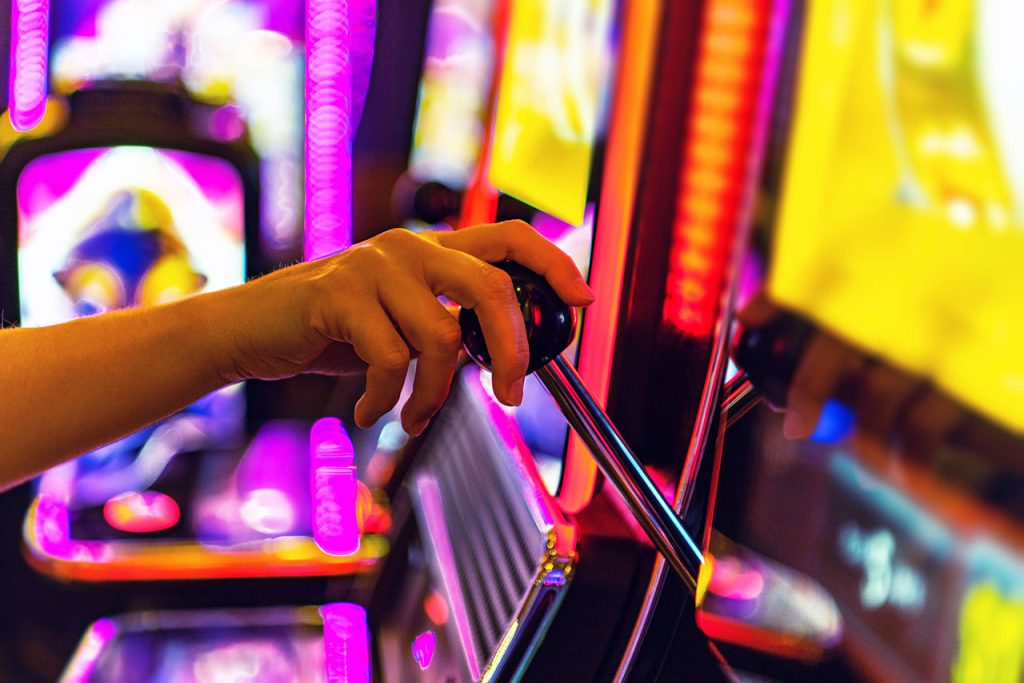 Woman playing on a slot machine.