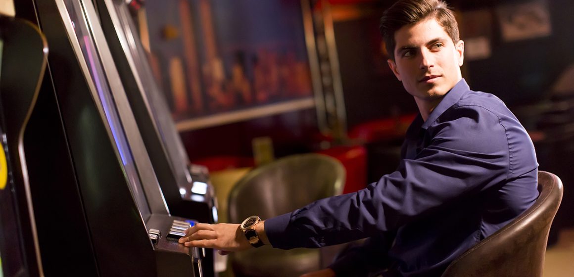 Picture of a young man with a slot machine.