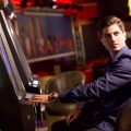 Picture of a young man with a slot machine.